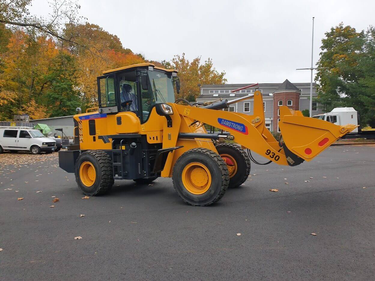 yellow wheel loader in a parking lot