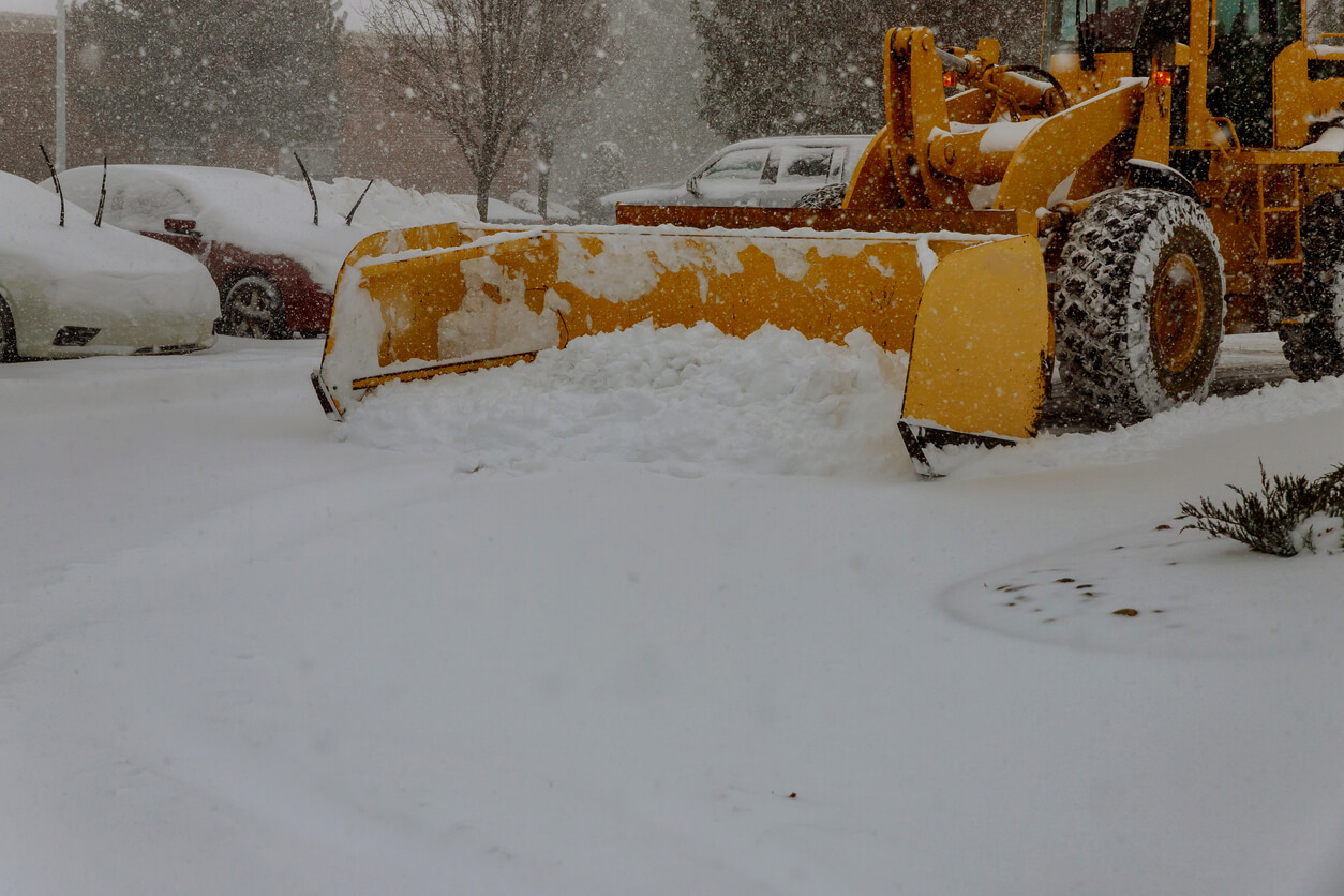 Wheel loader cleaning snow