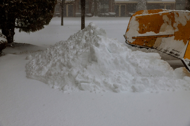 Fragment of a wheel loader that cleans snow from the roadway from city road